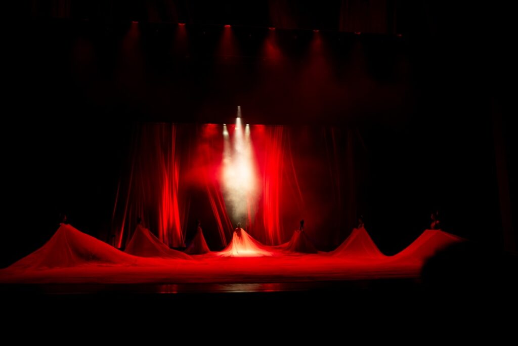 Theater stage with dramatic lighting during a performance