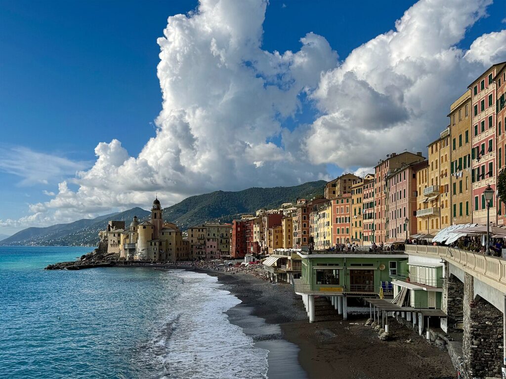 Camogli with its characteristic colorful houses reflected in the harbor