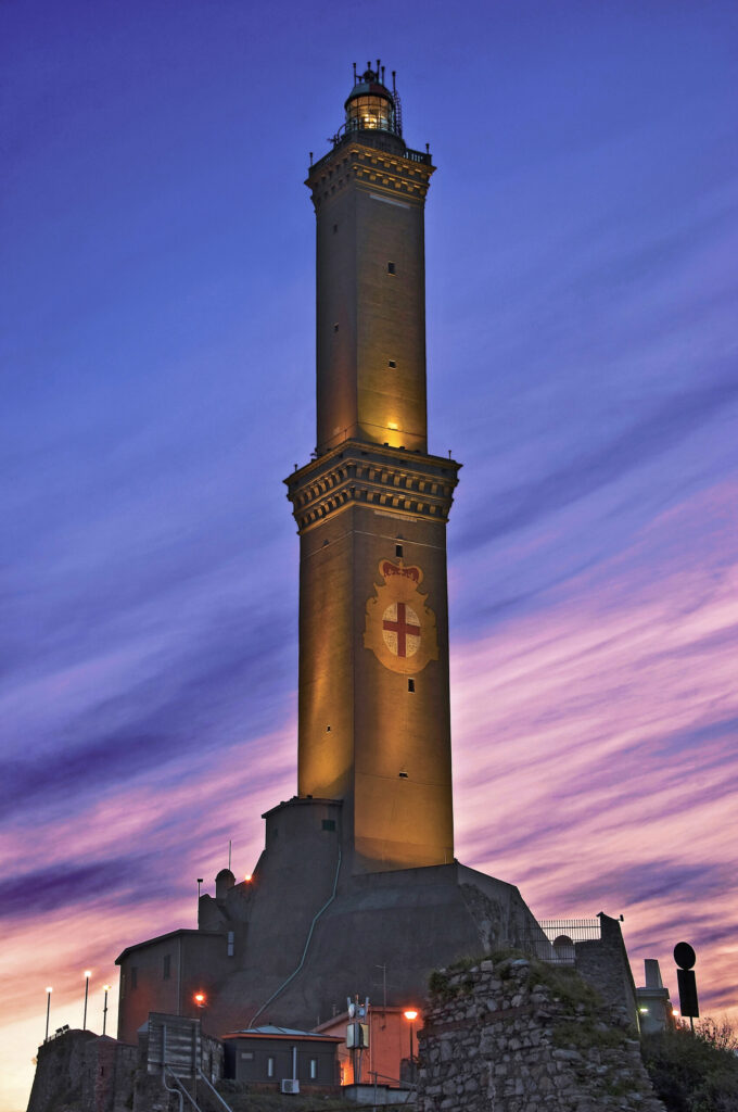 The Lanterna di Genova lighthouse illuminated at sunset