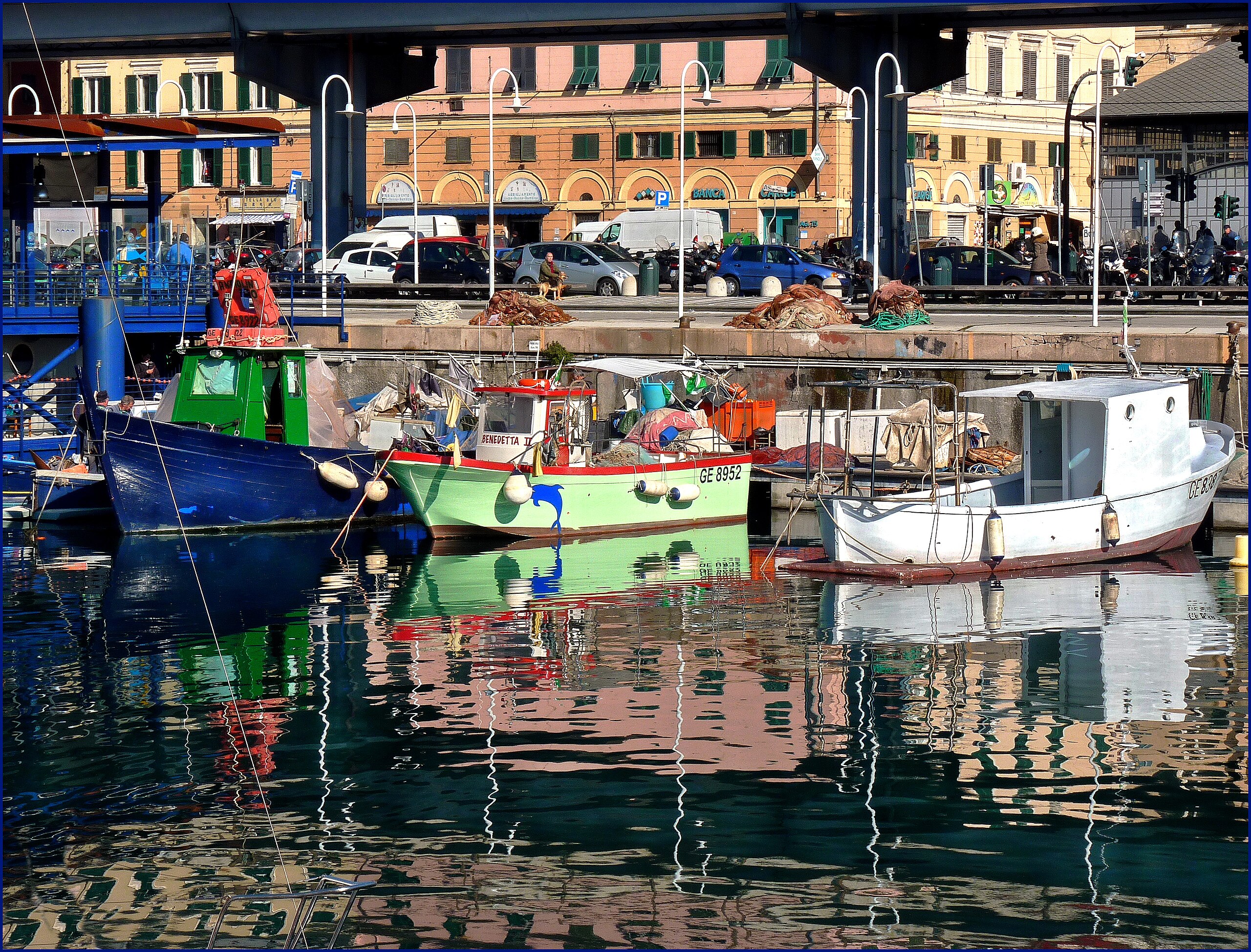 Fishing boats at the Porto Antico of Genoa with nets and gear on the quay