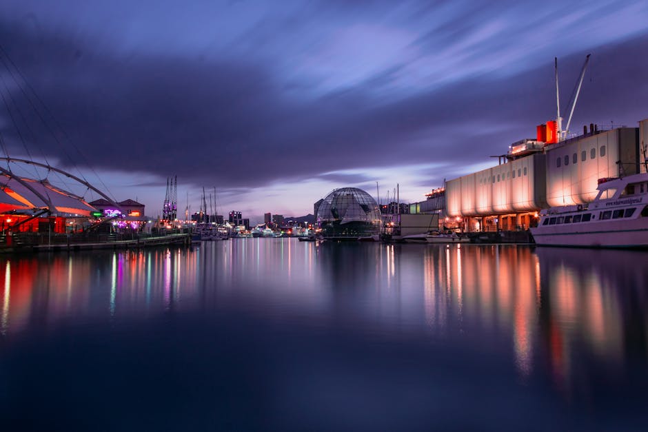 The Porto Antico of Genoa at dawn with a historic sailing ship moored at the wharves
