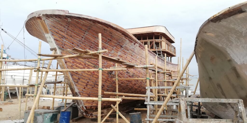 Master carpenter at work building a gozzo in a traditional shipyard