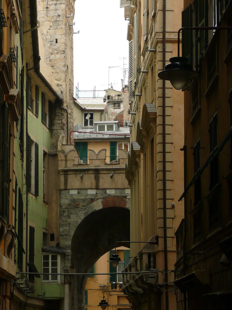 A narrow alley of the Genoese caruggi with stone arch